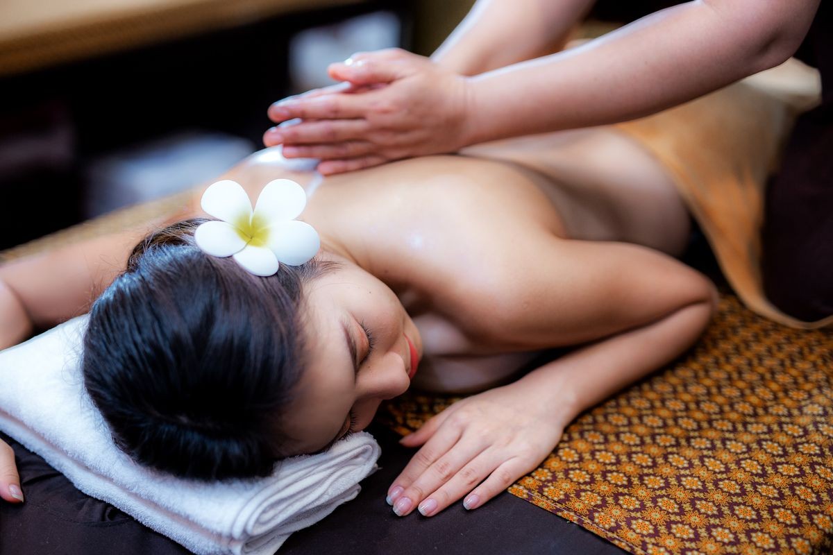 Young Asian woman lying on bed in spa massage.